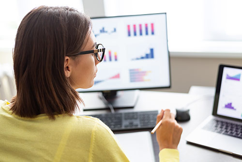 Three women working at a laptop